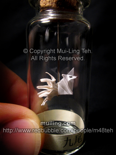 A cute white miniature origami kyuubi no kitsune (nine-tailed fox) in a bottle, with label "kyuubi" (nine tails) Japanese.
