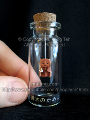 An miniature origami bear in a bottle, holding a miniature origami crane in hope for the victims of the 2016 Kumamoto earthquake